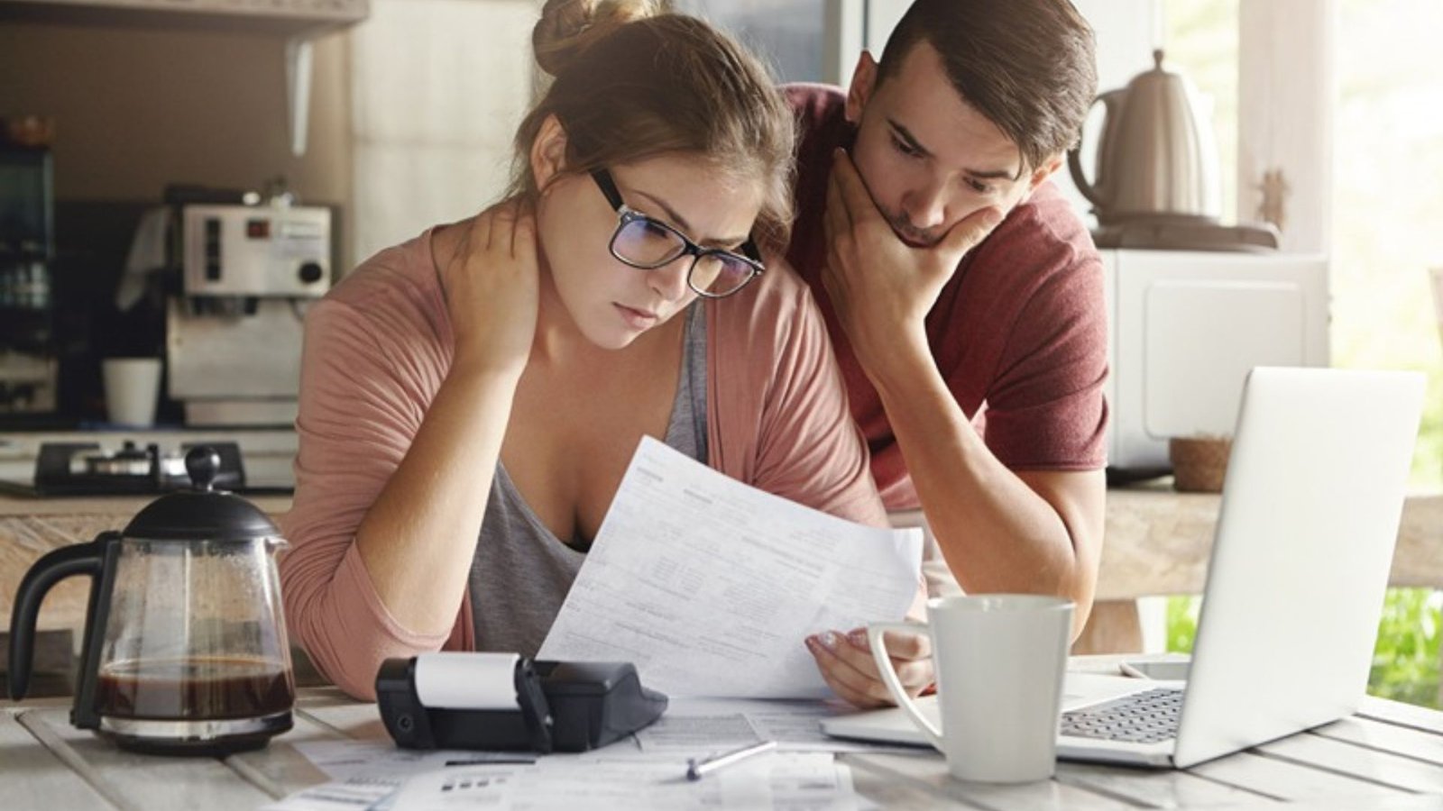 A Woman and a Man Looking at a Financial Statement 